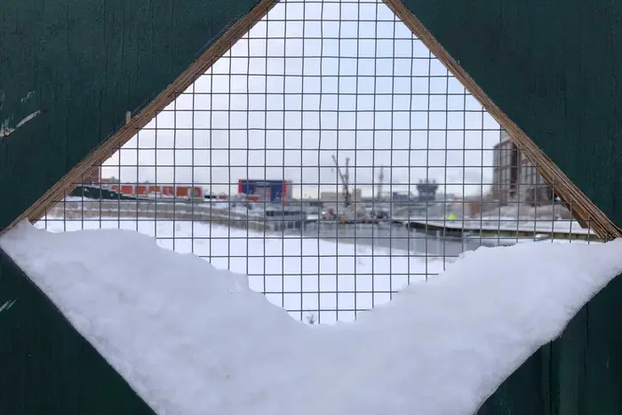 snow falls on a construction site